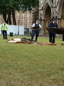 Police standing on tents at Westminster Abbey